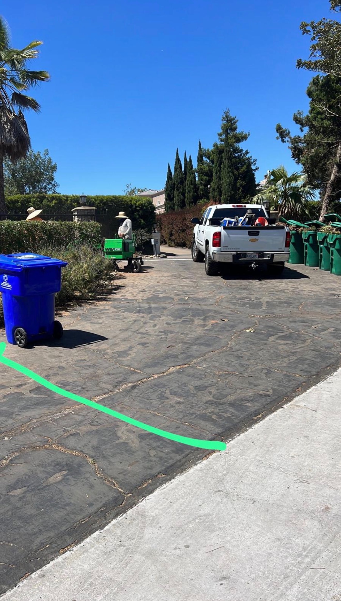 Driveway before — cracked asphalt