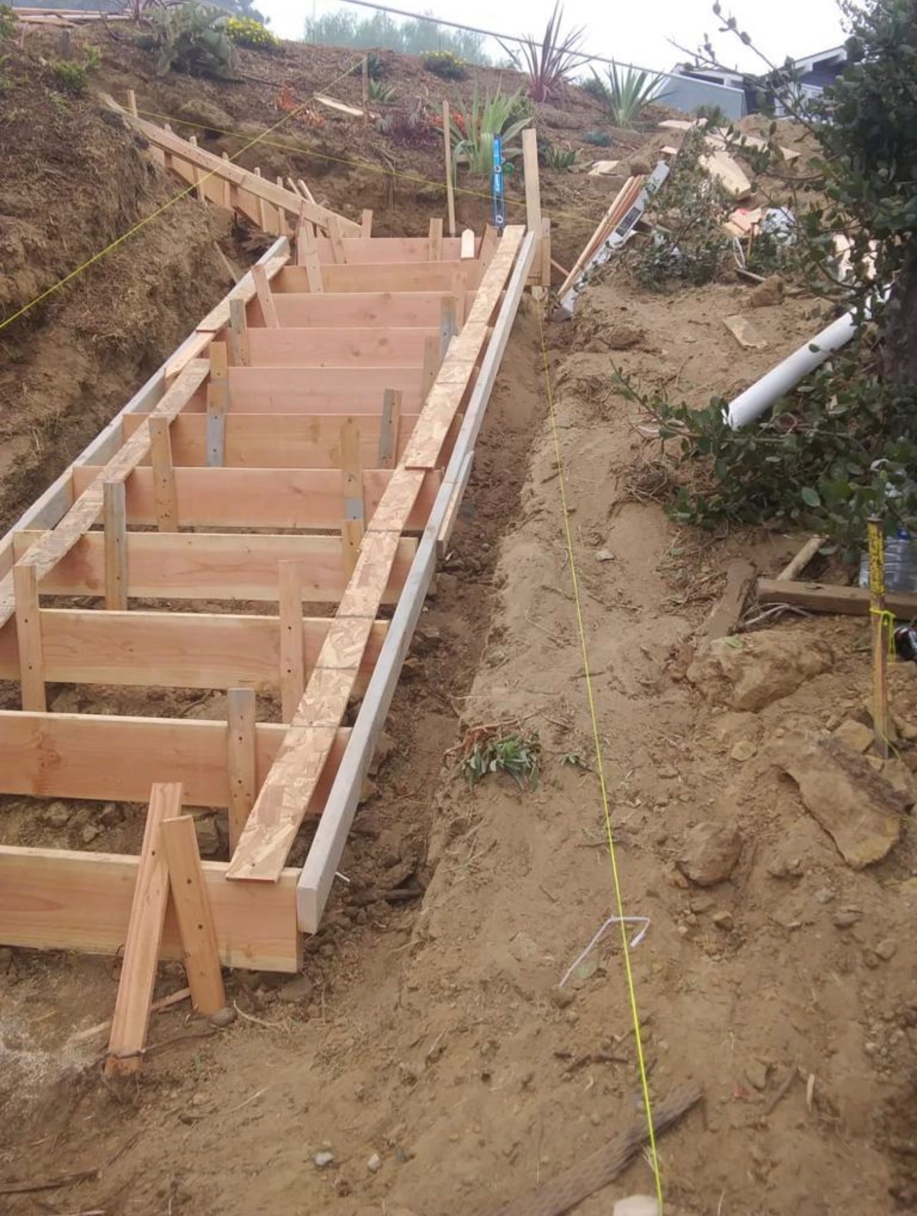 Hillside staircase before — wood framing