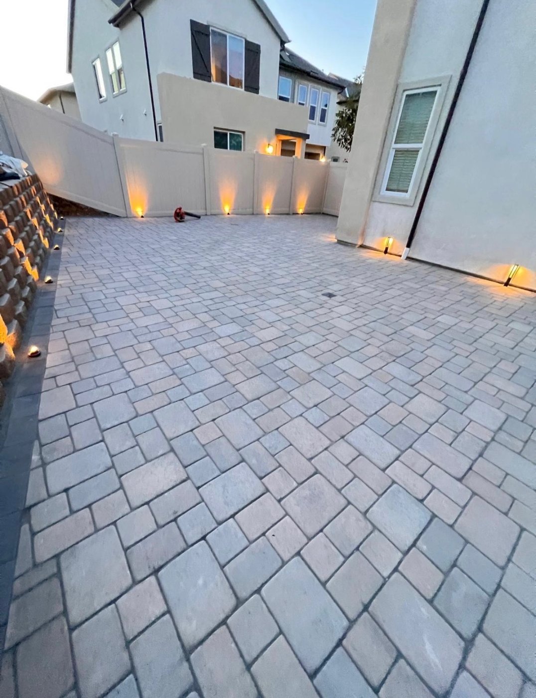Backyard paver patio with uplighting