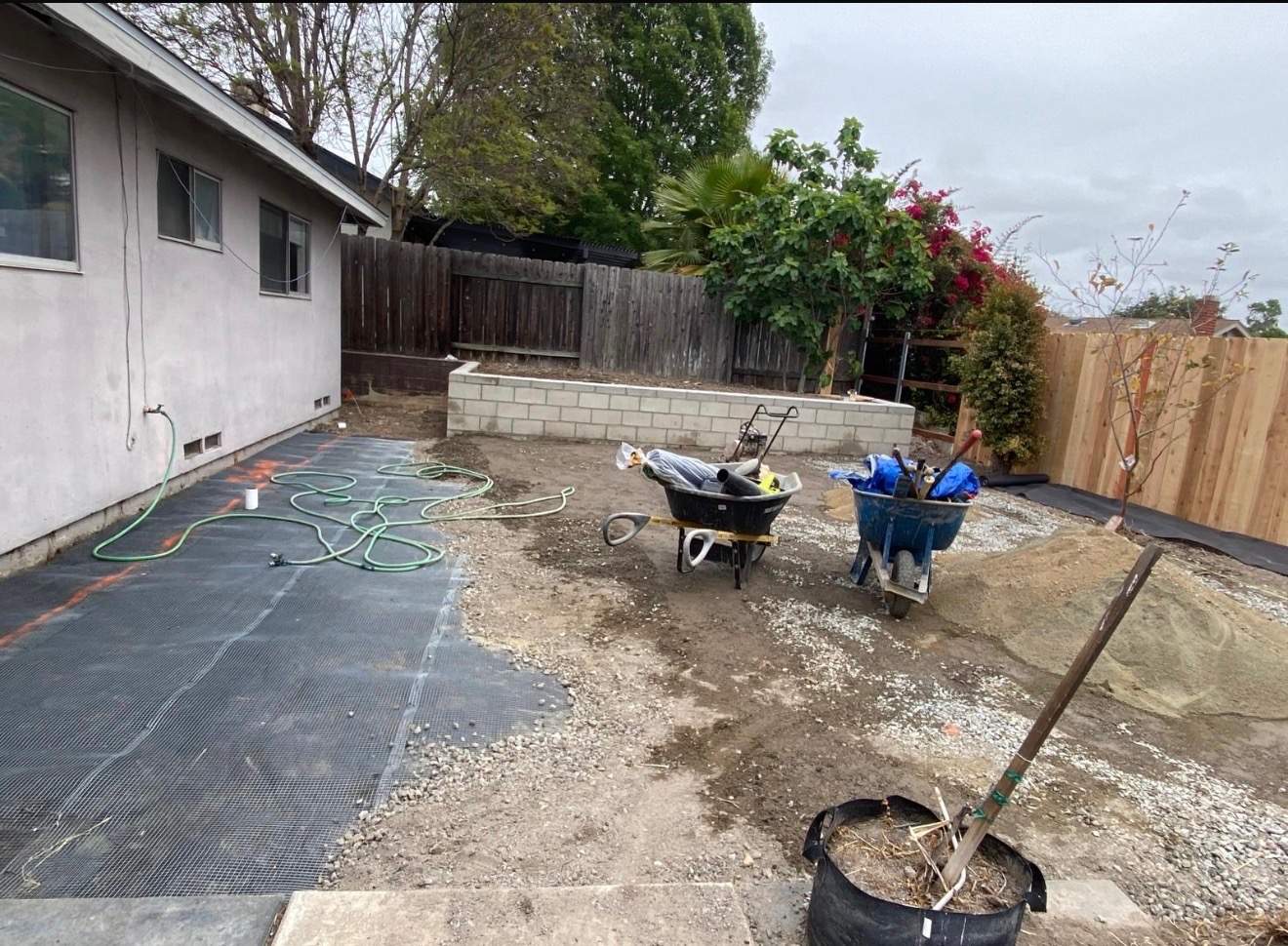 Backyard before — weed barrier and base prep for turf