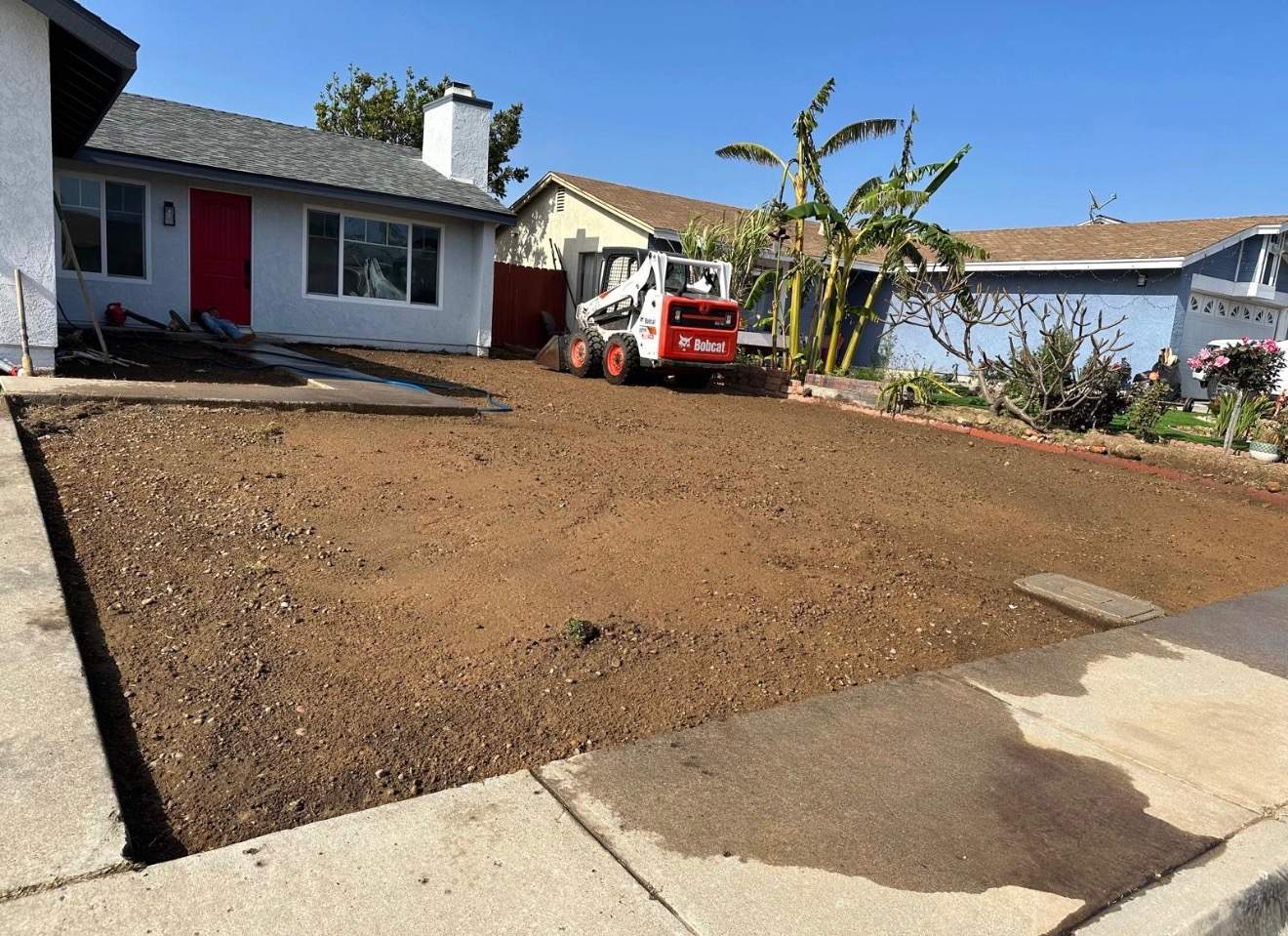 Front yard before — grading with Bobcat